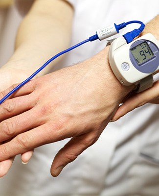 Man wearing sleep apnea test monitor.