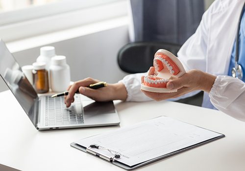 A dentist reviewing their patient’s treatment plan