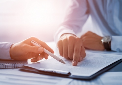 Two people looking at paper on clipboard