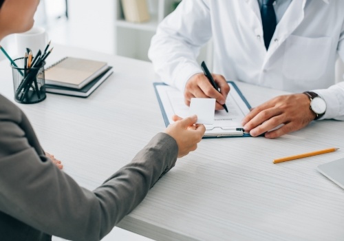 Patient handing a payment card to their doctor