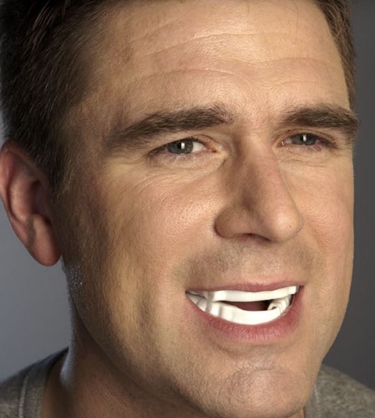 Man wearing white oral appliance in Glendale over his teeth