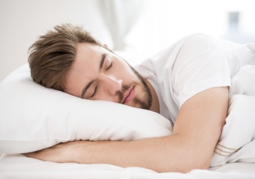 Young man sleeping soundly on his side