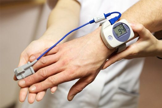 Sleep Apnea Testing: Doctor checking a patient’s vitals during sleep test
