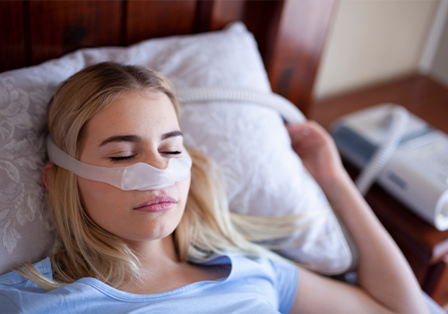 Sleeping woman wearing C P A P mask