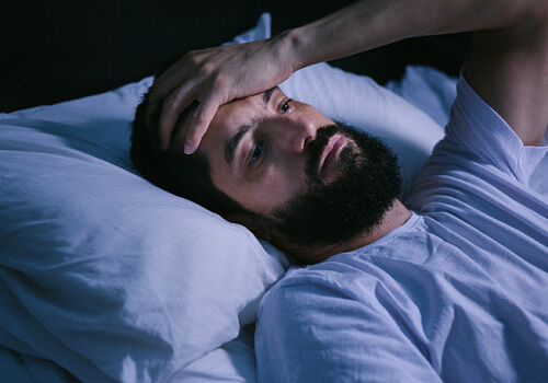 man tired and awake at night