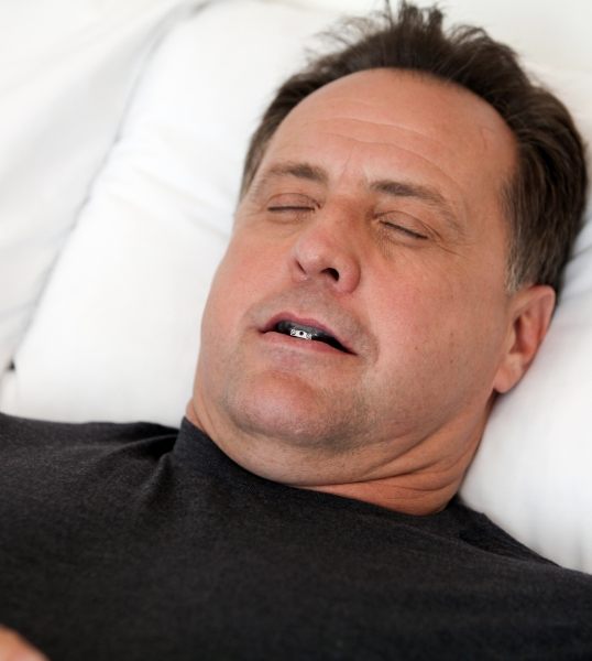Sleeping man wearing oral appliance in Glendale